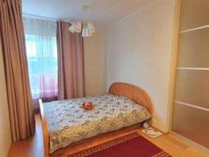 ein Schlafzimmer mit einem Bett mit einem ausgestopften Tier darauf in der Unterkunft Bright 3-room apartment in Mustamäe in Tallinn