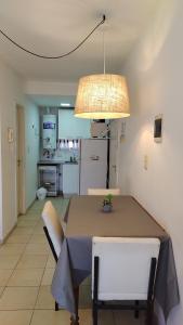 a dining room with a table and a light fixture at Moreno1300/9 in Rosario