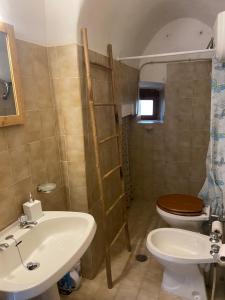 a bathroom with a sink and a toilet at La Casa nell’Antico Borgo in Alvito