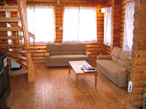 a living room with two couches and a coffee table at Awone Shirakami Juniko in Fukaura