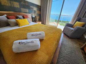 a hotel room with a large bed with towels on it at Rosegarden View in Velas