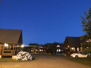 a row of houses at night with a car parked in the driveway at Awone Shirakami Juniko in Fukaura