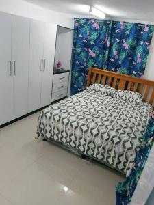 a bedroom with a bed in a room at Barrett Accommodation Apartment in Suva