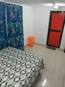1 dormitorio con 1 cama y puerta roja en Barrett Accommodation Apartment en Suva