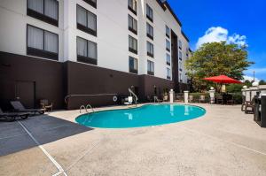 a swimming pool in front of a building at Comfort Suites Northlake in Charlotte
