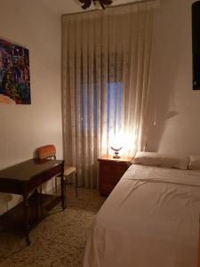 1 dormitorio con cama, escritorio y ventana en Private Room with Queen Bed, en Salamanca