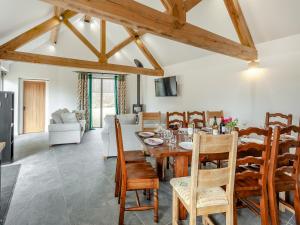 a dining room with a table and chairs at The Maltings - Uk44460 in Kingscote
