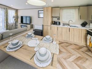 a living room with a table with dishes on it at Stonewood Country Lodge in Kelsall