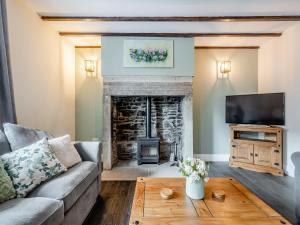 a living room with a couch and a fireplace at South View in Castleside