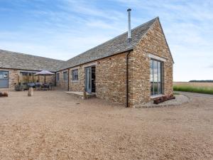 a brick building with a patio in front of it at The Granary - Uk44454 in Kingscote