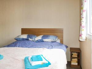 a bedroom with a bed with blue towels on it at Riverview in Dogdyke