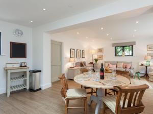 a dining room and living room with a table and chairs at The Dairy in Cheriton