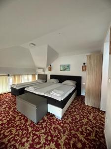 a bedroom with a large bed and a red carpet at Residence Mahala in Sarajevo