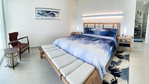 a bedroom with a bed and a bench in it at Casa Azul LV 2-4, Costa Divina in La Choya
