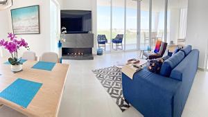 a living room with a blue couch and a fireplace at Casa Azul LV 2-4, Costa Divina in La Choya