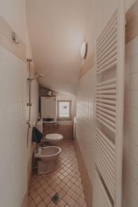 a small bathroom with a toilet and a sink at [Centro] Casa con parcheggio in Ravenna