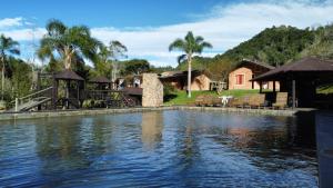 聖博尼法喬的住宿－Pousada das Hortênsias，水边的一座房子,有一个游泳池