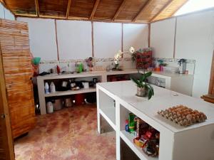 a kitchen with white counters and a counter top at Valle del Cardón in Villavieja