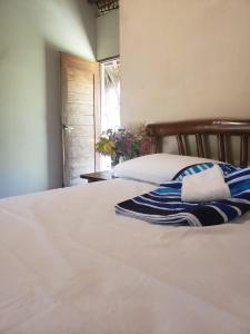 a bedroom with a bed with a blue and white blanket at The Grand Mango in El Gigante