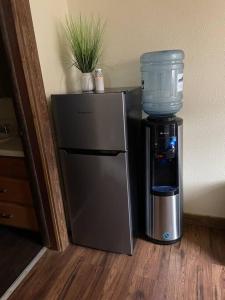 a coffee maker and a water cooler in a room at Parkway Yellowstone Guest House Apartment #5 in Gardiner