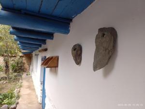 a wall with two pieces of rocks on it at El Arriero Hostel B&B in Ollantaytambo