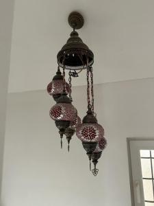 a chandelier hanging from a ceiling in a room at Residence Mahala in Sarajevo