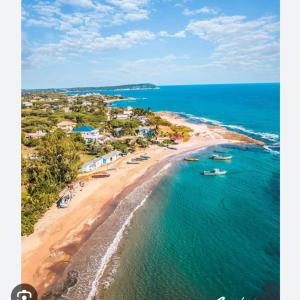 an aerial view of a beach with boats in the water at Mango tree Oasis in Treasure Beach