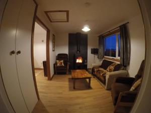 a living room with a couch and a table at Madras cottage Orkney Islands in Harray