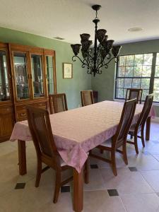 a dining room table with a pink table cloth and chairs at Awesome shared Villa 20 minutes from the beach in Melbourne