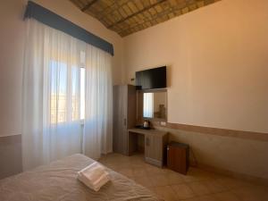 a bedroom with a bed and a large window at Hotel Alex Square in Rome