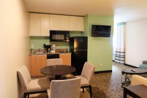 a kitchen and dining room with a table and chairs at GreenTree Suites Eagle / Vail Valley in Eagle