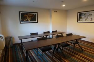 a meeting room with two tables and chairs at GreenTree Suites Eagle / Vail Valley in Eagle