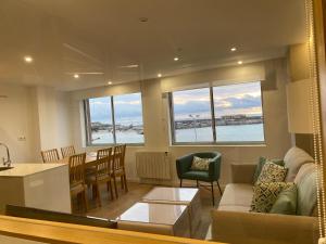 a living room with a couch and a table at Apartamento en Primera Línea del Mar in A Guarda