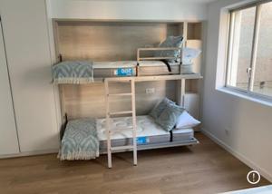 a room with two bunk beds and a window at Apartamento en Primera Línea del Mar in A Guarda