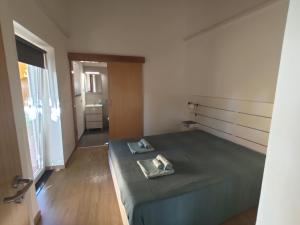 a bedroom with a bed with a towel on it at Quinta das Bicas AL in Angra do Heroísmo