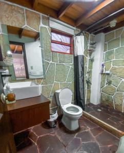 a bathroom with a toilet and a sink and a shower at CASA DE PIEDRA EL ZAPATO in Suesca