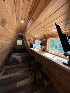 a room with a bed and a desk in a cabin at Acres Away in Penn Yan