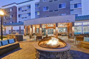 a patio with a fire pit in front of a building at Courtyard by Marriott Long Island Islip/Courthouse Complex in Central Islip