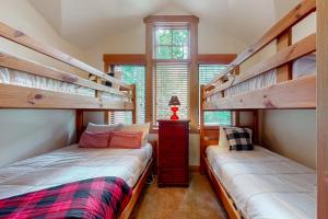 two beds in a room with two bunk beds at Golden Crown Cabin in Breckenridge