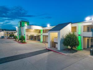 a hotel with a gas station in a parking lot at Quality Inn in Fayetteville