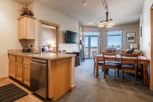 a kitchen and dining room with a table and a dining room at Sunstone # 329 in Mammoth Lakes