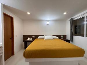 Postel nebo postele na pokoji v ubytování Hotel Quinta Luna Zacatlán