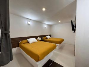Postel nebo postele na pokoji v ubytování Hotel Quinta Luna Zacatlán
