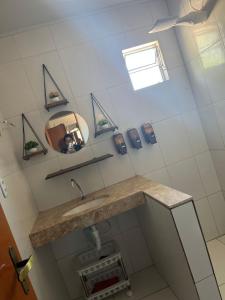 a bathroom with a sink and a mirror at Canto da Gaivota Lençóis Maranhenses in Santo Amaro