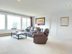 a living room with a couch and a table at Tranquil Retreat Spacious 2-Bedroom on a Serene Acreage in Kelowna