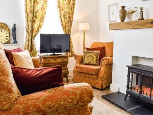 a living room with furniture and a fireplace at The Nook in Bishop Auckland