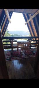 a wooden table sitting in a room with a view at Vikendica A Vlasic in Vlasic