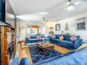 a living room with blue couches and a table at Welton House in Orby