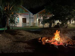a fire pit in front of a house at night at TC Garden Resort in Kuah