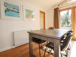 a dining room with a wooden table and chairs at 4 Water's Edge in Looe